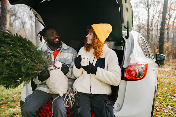 istock Couple having a tea in the forest and preparing tree for Christmas. 2254138128