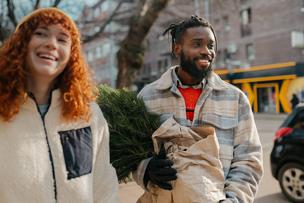 istock Carrying the Christmas tree after shopping 2254139368