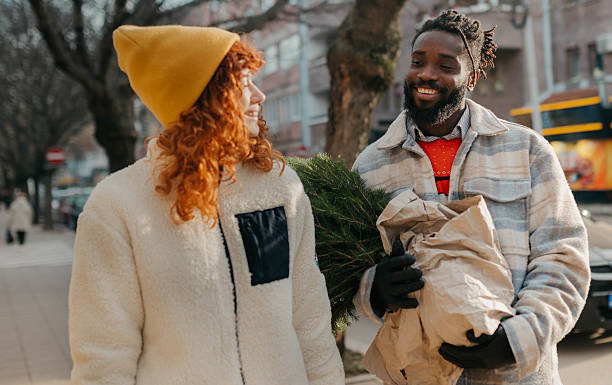 istock Carrying the Christmas tree after shopping 2254139385