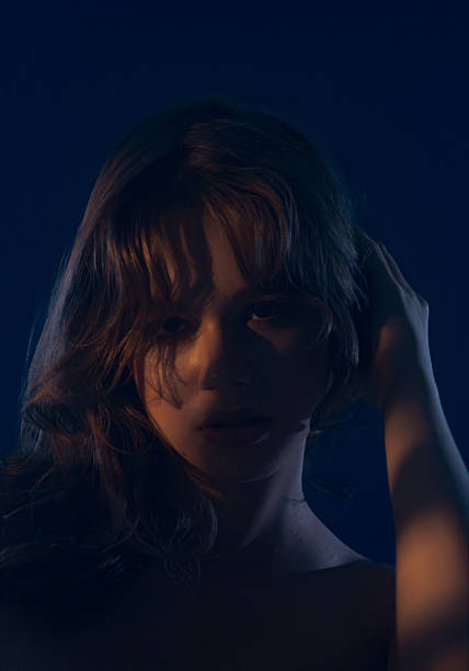 istock Mysterious Woman in Dramatic Lighting Portrait 2254139810