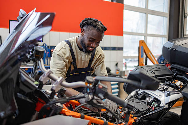 istock Repairman Examining Motorcycle 2254139873