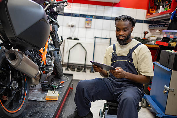 istock A mechanic sits in a workshop near a motorcycle 2254140002