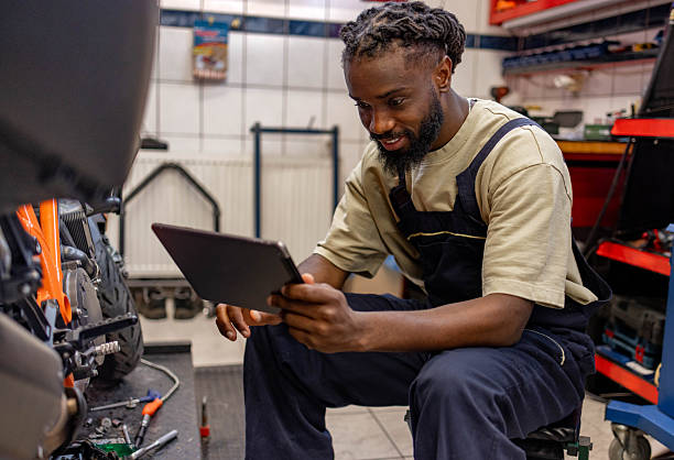 istock A mechanic sits in a workshop near a motorcycle 2254140192