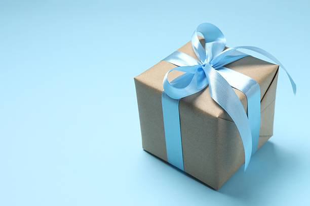 istock Beautiful gift box on blue backgroundd. close-up view 2254140410