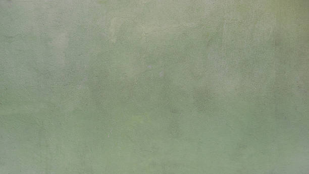 istock Full frame texture of a sage green plaster wall with subtle grain. 2254140433