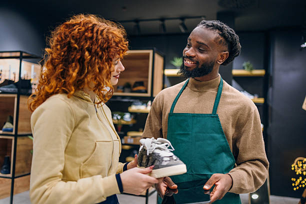istock Customer and seller in a shoe store 2254141322