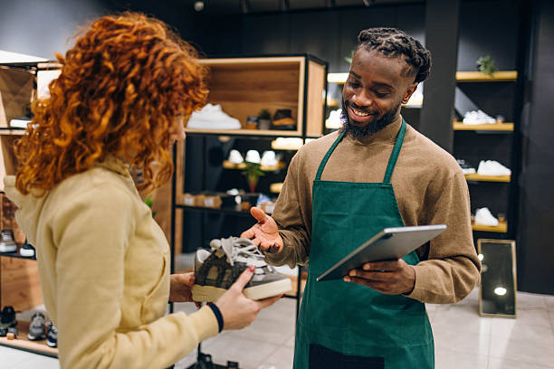 istock Customer and seller in a shoe store 2254141332