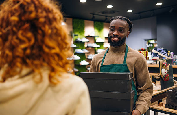 istock Shoe salesman in a store 2254141360