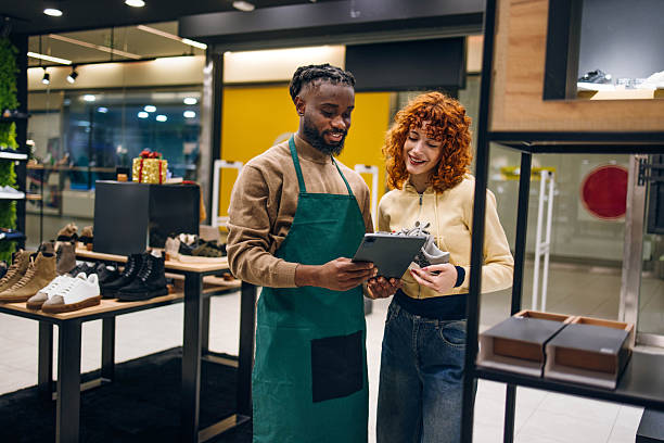 istock Customer and seller in a shoe store 2254141383