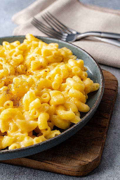 istock Delicious mac and cheese in a plate on grey stone  background 2254141426