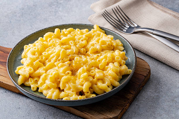 istock Delicious mac and cheese in a plate on grey stone  background 2254141449