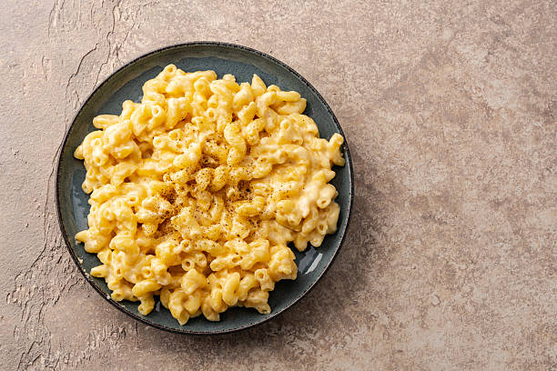 istock Delicious mac and cheese in a plate on vintage stone  background 2254141617