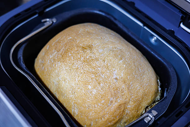 istock Freshly Baked Homemade Bread Inside an Automatic Bread Maker Machine, Golden Crust Loaf Ready to Eat, Home Bakery and Kitchen Appliance Concept 2254141693