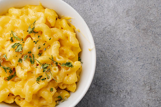 istock Delicious mac and cheese in a bowl on grey stone background 2254141842