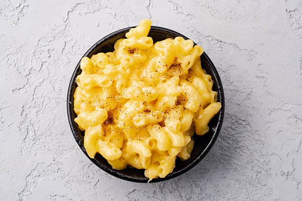 istock Delicious mac and cheese in a bowl on grey stone background 2254141979