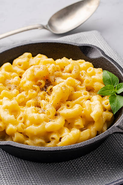 istock Delicious mac and cheese in a pan on grey stone background 2254142024