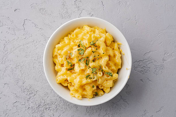 Delicious mac and cheese in a bowl on grey stone background