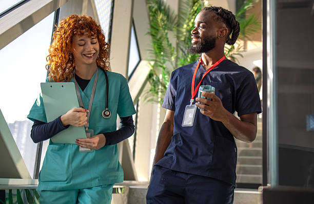 istock Full of young students communicating while walking through medical university 2254142574