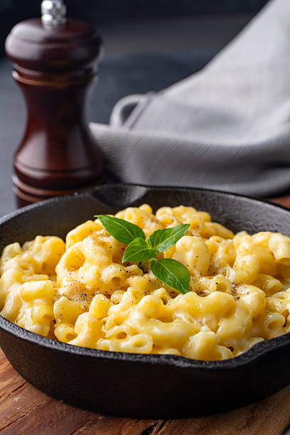 istock Delicious mac and cheese in a pan on black stone background 2254142682