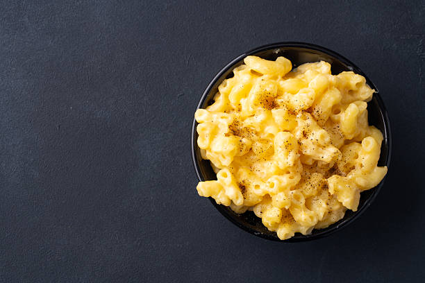 Delicious mac and cheese in a bowl on black  stone background