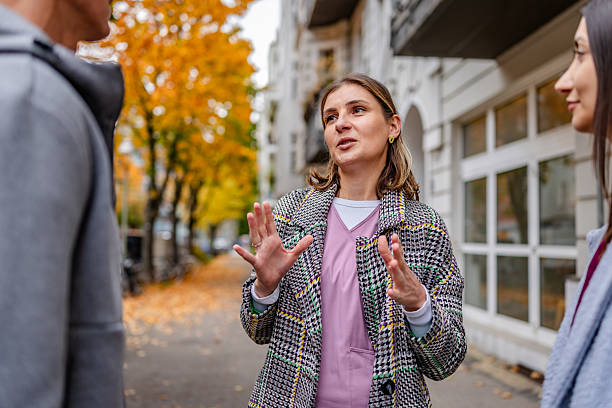 istock Healthcare workers from diverse backgrounds discuss their day while walking outdoors during fall 2254142760