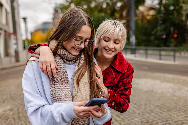 istock Two friends enjoy their time outdoors in Berlin while walking and smiling on a sunny autumn day 2254143420