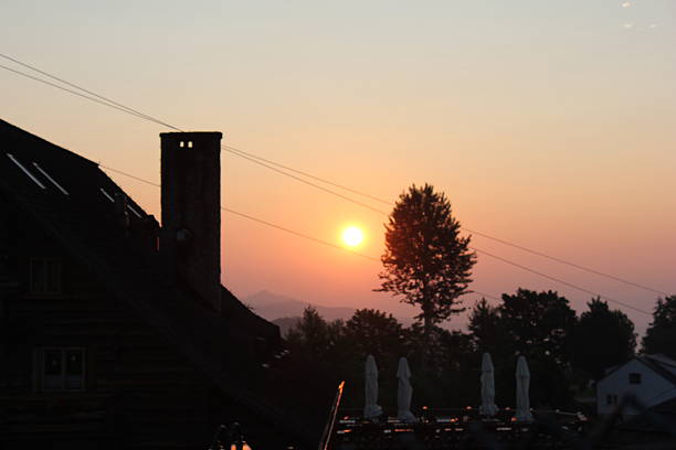 Silhouette of House and Tree at Sunset