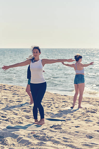 istock Group yoga session on Baltic Sea sandy beach during sunny day 2254151914