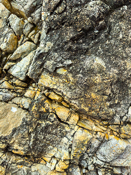 istock Textured rock formations showcasing layers of time and history on a coastal cliff during daylight hours 2254152098