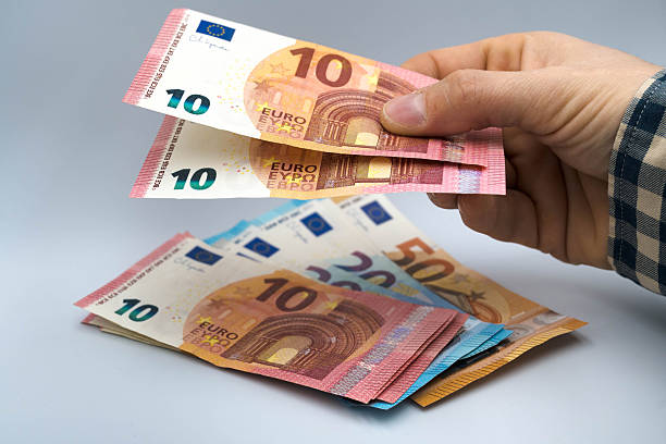 istock Euro banknotes in a man's hand. 2254153804