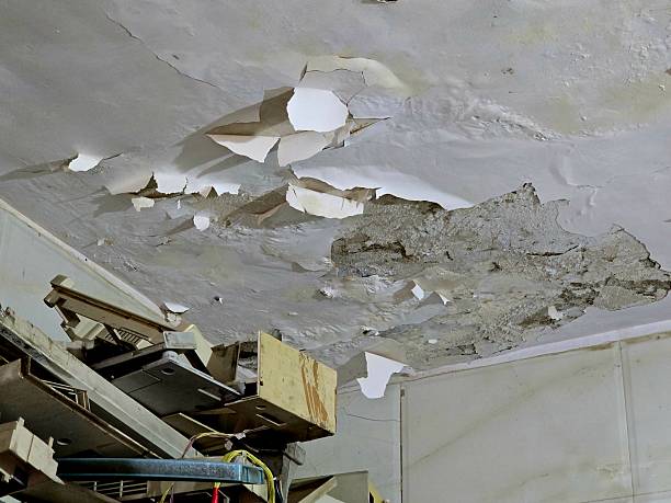 istock Peeling and Cracked Ceiling with Falling Plaster Showing Water Damage Inside Old Building 2254153846