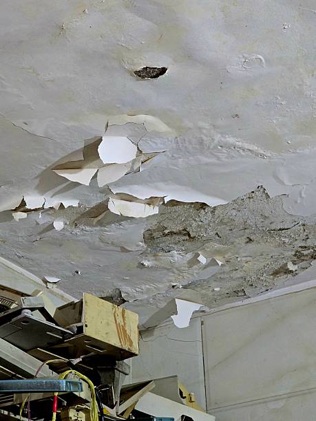istock Peeling and Cracked Ceiling with Falling Plaster Showing Water Damage Inside Old Building 2254153847