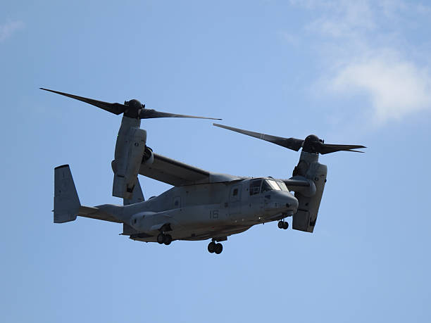 San Diego, California, USA - September 28, 2025: A Bell Boeing MV-22B Osprey tiltrotor aircraft flying in airplane mode with nacelles horizontal against a blue sky.