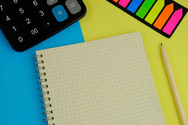 istock paper on yellow background. Empty Space for your text. business and education concept 2254159538