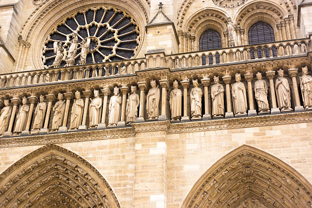 Paris, France: A renovated (2025) Notre Dame Cathedral facade (close-up), with a row of saints about the arches.
