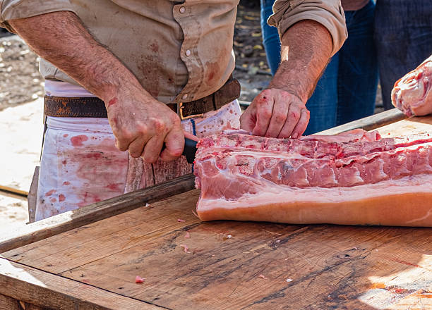 Butcher Cutting Pork Ribs