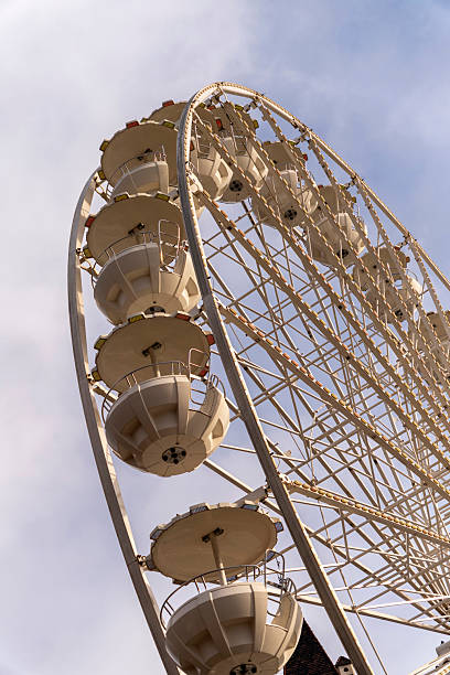 istock Large Ferris wheel with passenger cabins in a city during daylight hours 2254165591