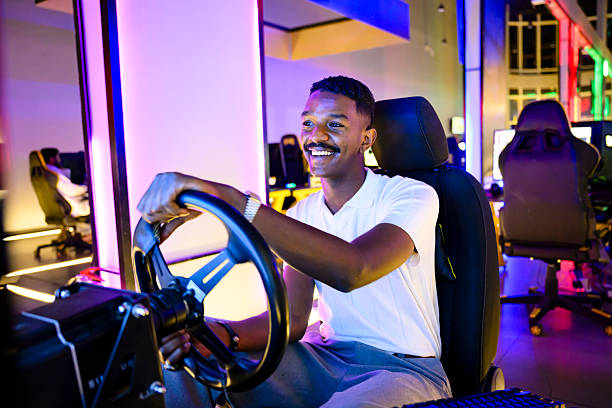 istock Young man enjoying race driving simulator at gaming arcade 2254169774