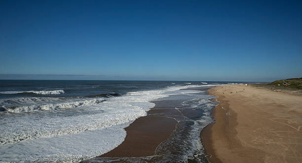 istock A huge wave crashes onto the beach.   . 2254172483