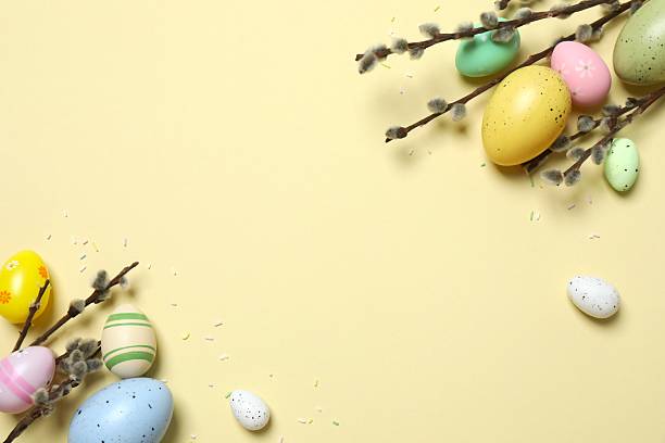 istock Colorful eggs, pussy willow branches, sweet sprinkles on a pastel beige background, space for text or advertising 2254173032