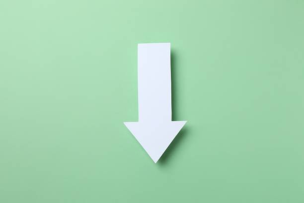 Paper arrow on color background, top view