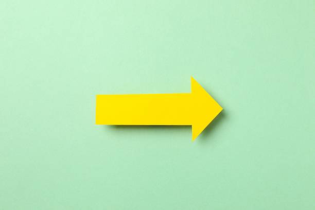 istock Paper arrow on color background, top view 2254174321
