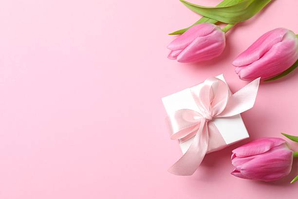 istock Beautiful fresh tulips with gift box on pink background 2254174346