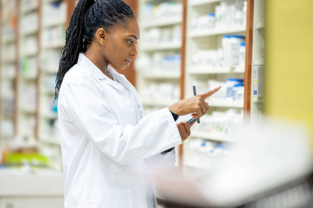 istock African American Female Pharmacist Examines Medicines On Pharmacy Shelves While Using Tablet 2254176132