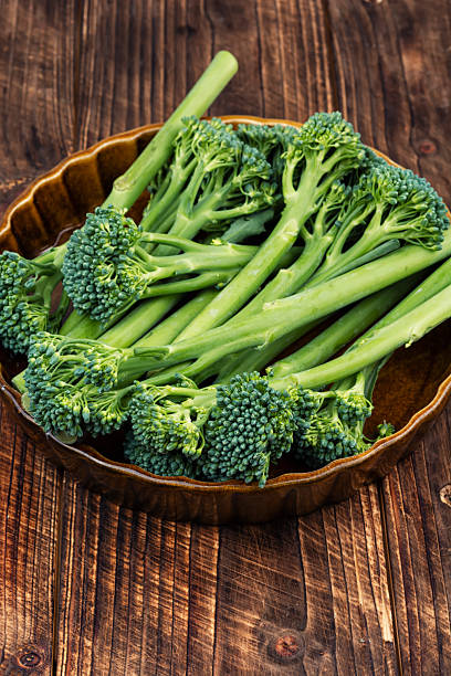 istock Organic Baby Broccoli Stalks with Seasonings on Kitchen Table. 2254176731