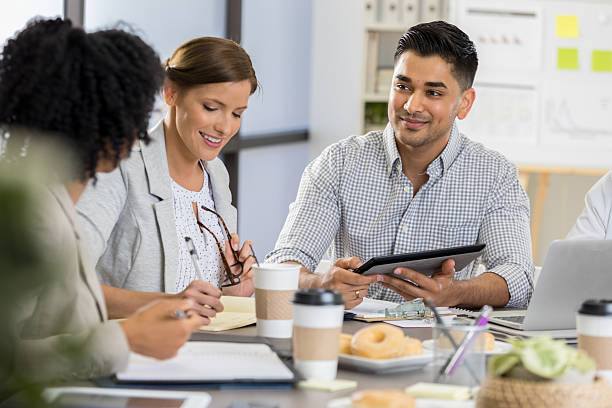 istock Diverse group of professionals collaborating on a project, discussing ideas in a bright office setting. 2254177516