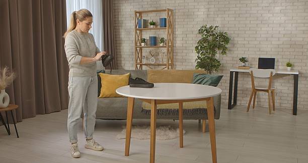istock Woman brushing Black Shoe in Modern Home Interior 2254178822