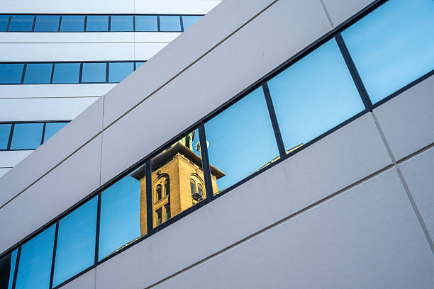 Historic architecture reflection in window of modern building, Rochester, New York, USA