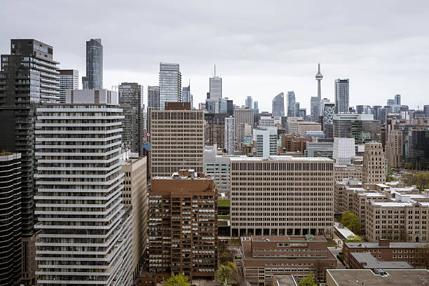 A wide cityscape view of downtown Toronto, Canada, seen from a high-rise luxury condominium. Modern skyscrapers, office buildings, and the iconic urban skyline create a contemporary metropolitan atmosphere. This image represents urban living, real estate, business district growth, and modern city lifestyle in North America.