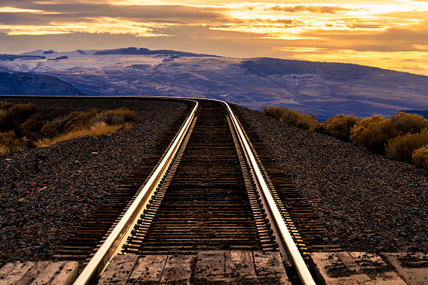 Blur image of railway at dusk with twilight sky in Nakhon Ratchasima or Korat province, Thailand. Transportation abstract background. in Siam
